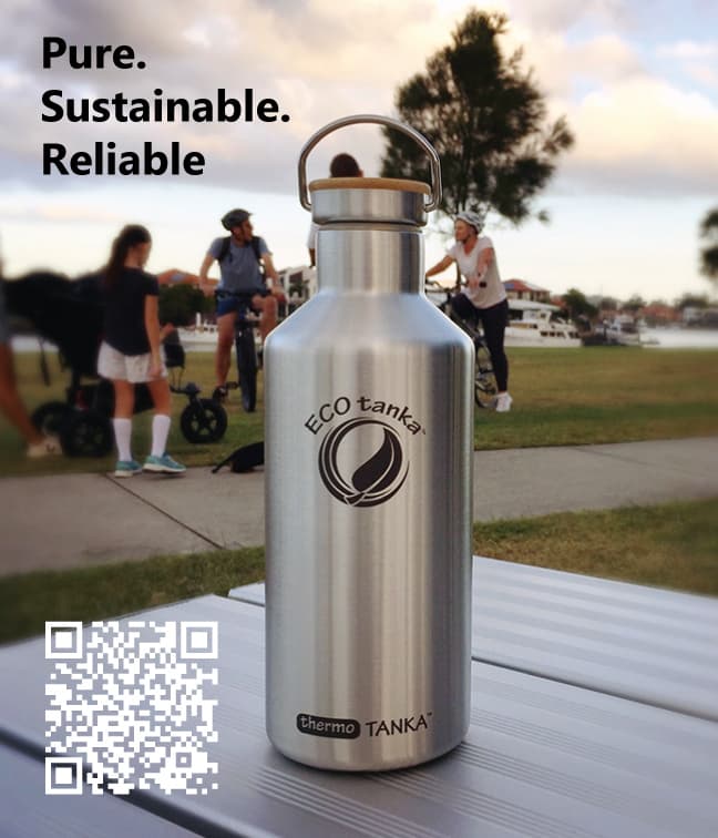 An ECOtanka bottle on a park table with cyclists behind it
